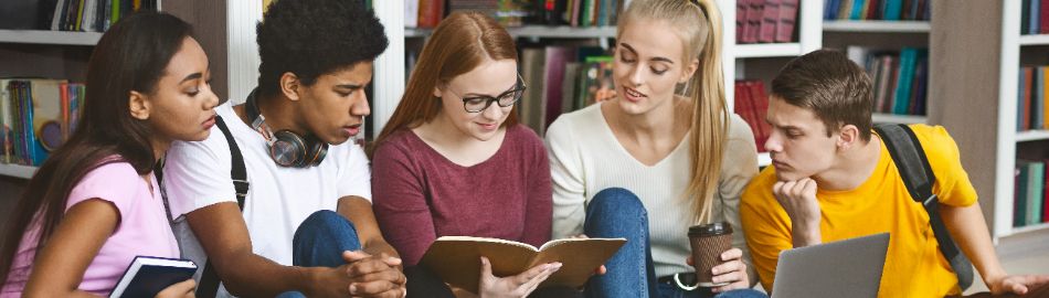 Image of students looking at book